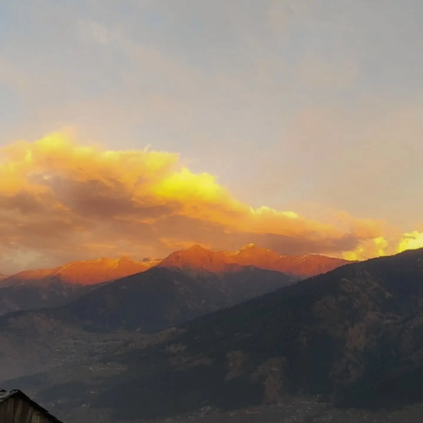 Golden sunset clouds over a Himalayan ridge