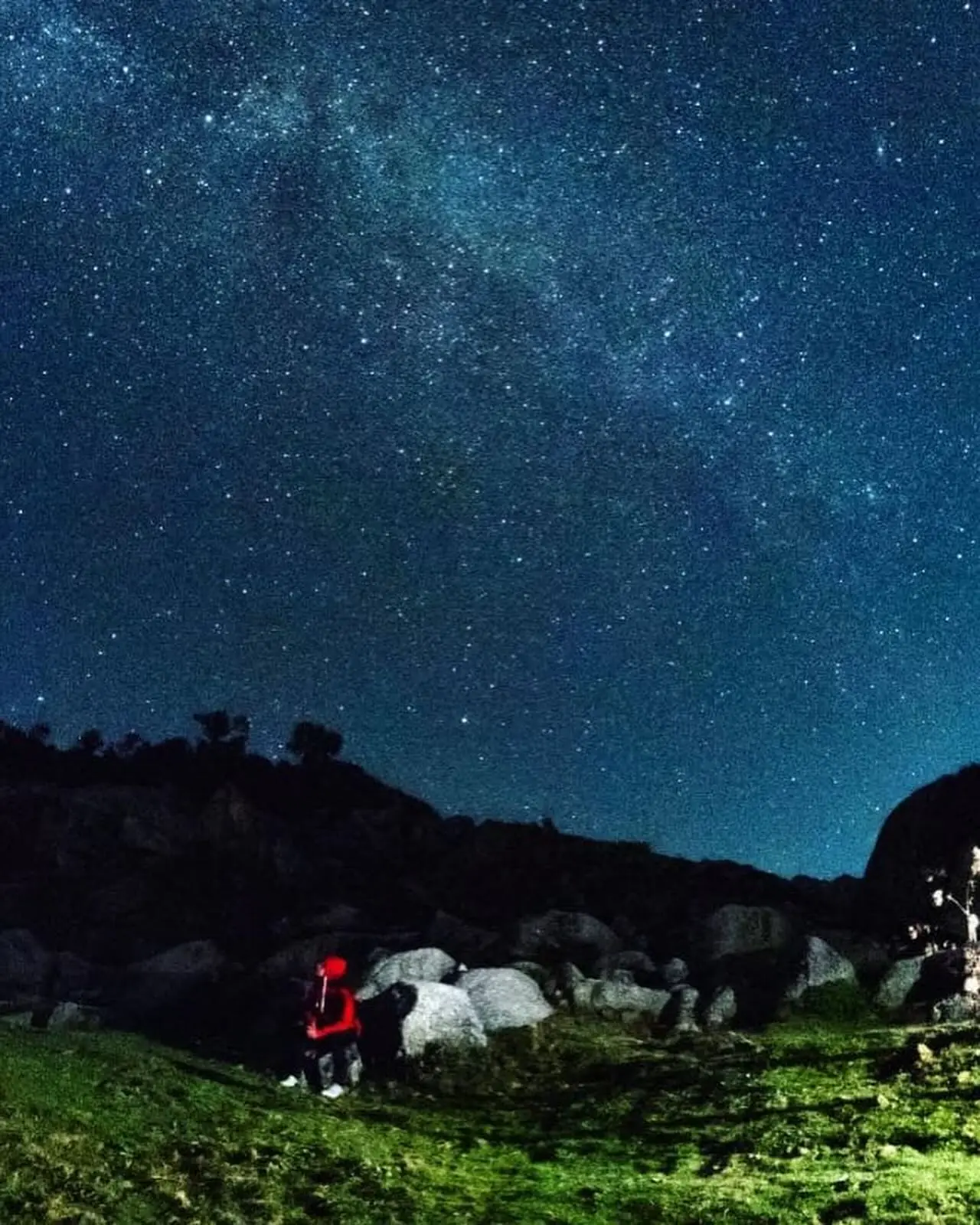 The Milky Way over a mountain campsite at night